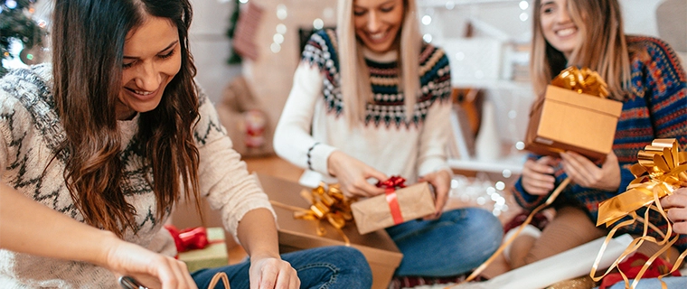 Women unwrapping Christmas presents