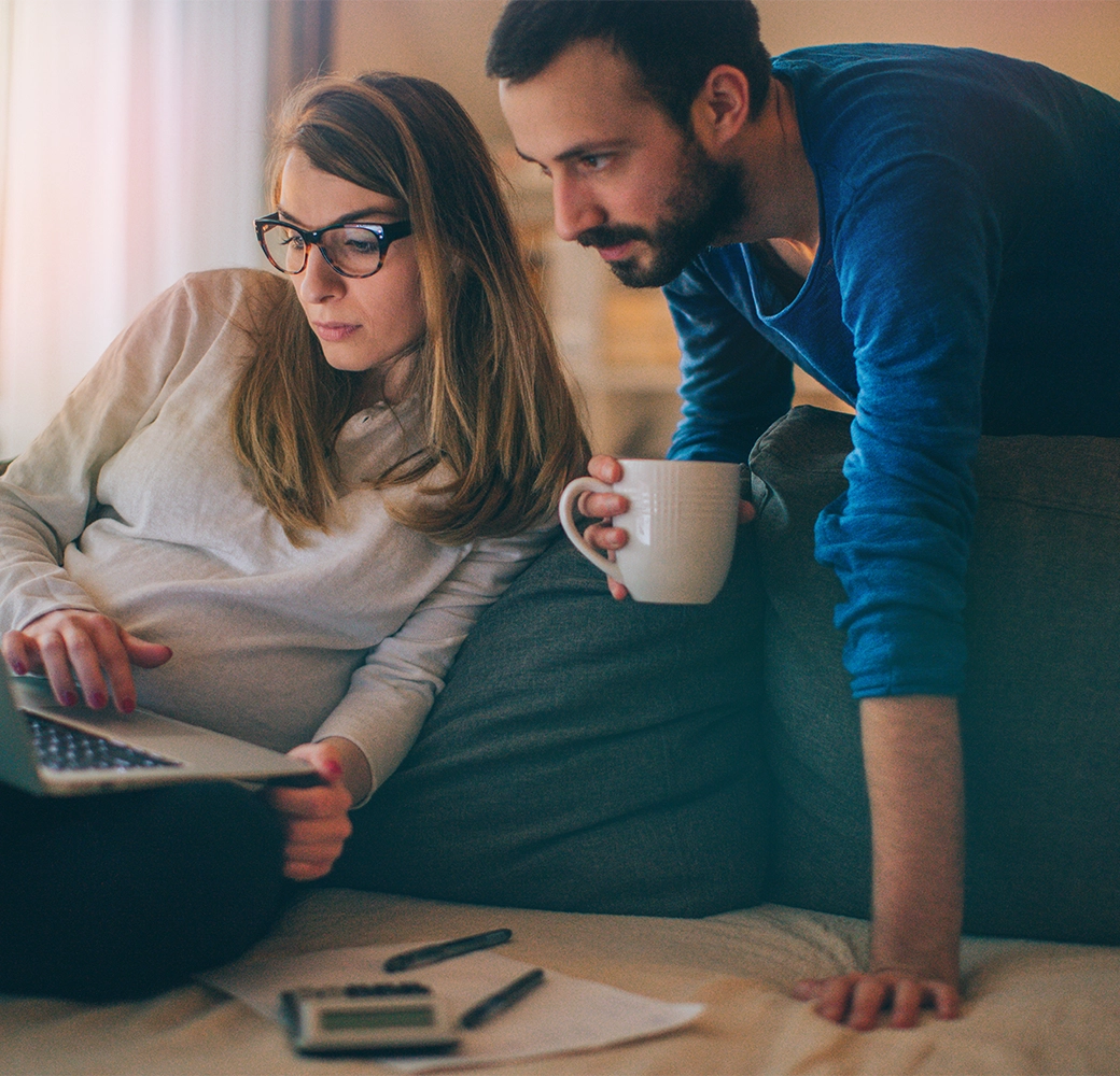 Couple reviewing tax information on laptop
