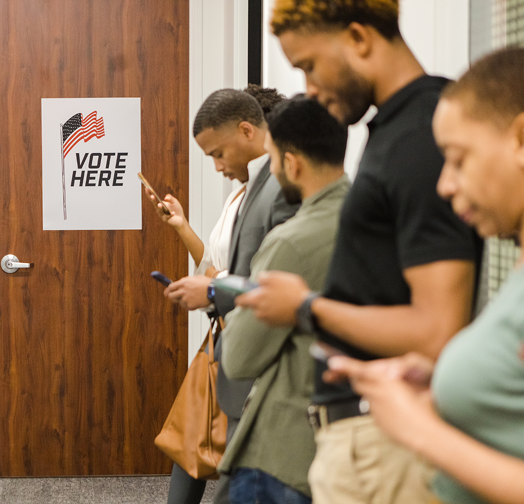 Group of people waiting in line to vote for an election