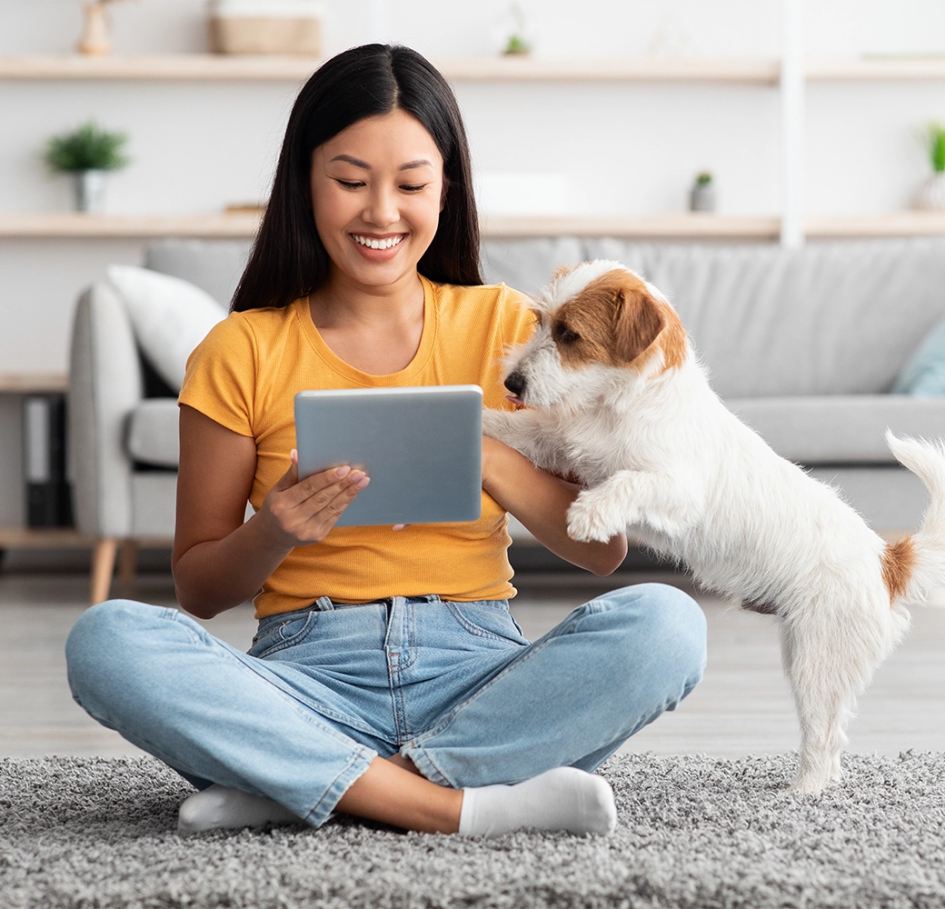 Woman and dog looking at ipad