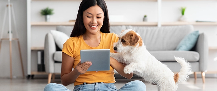 Woman and dog looking at ipad