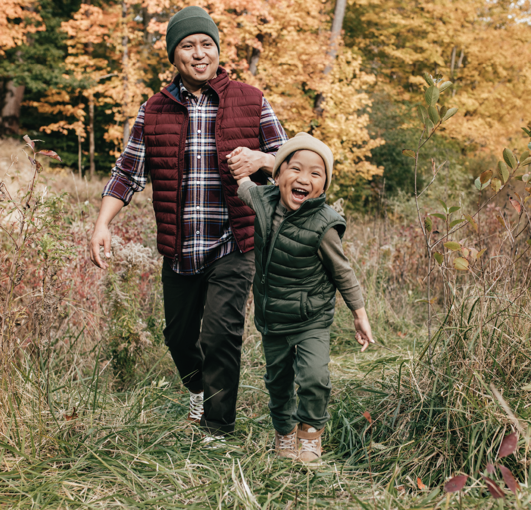 Dad and preschool-age son in the park during fall.