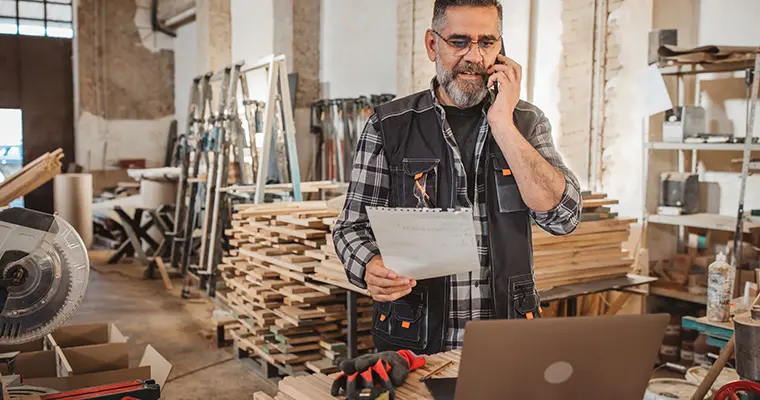 Man on the phone in woodshop
