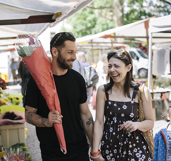 Couple walking through farmers market