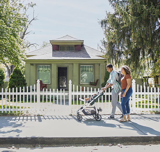 Couple walking baby in stroller