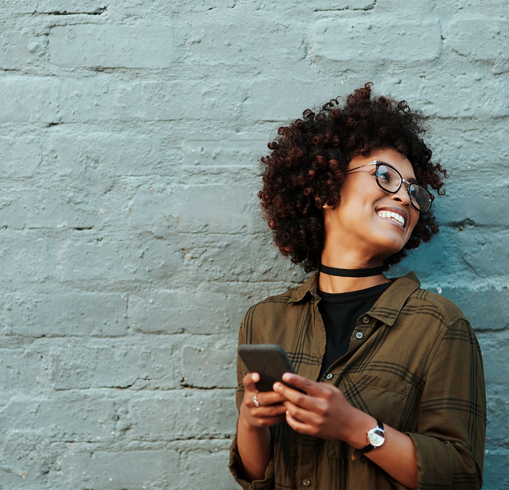 Woman holding phone and smiling