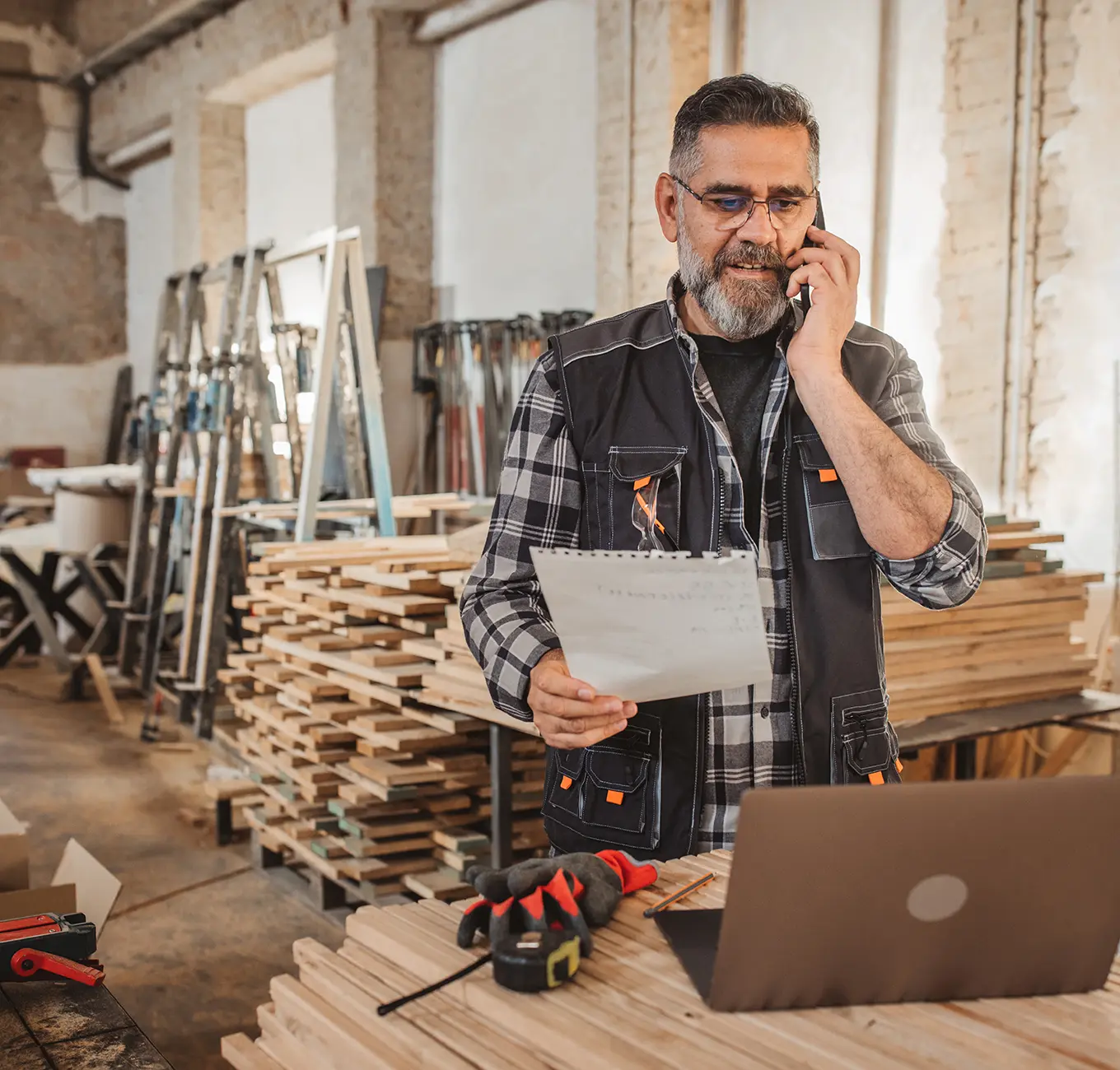 Man on phone in woodshop