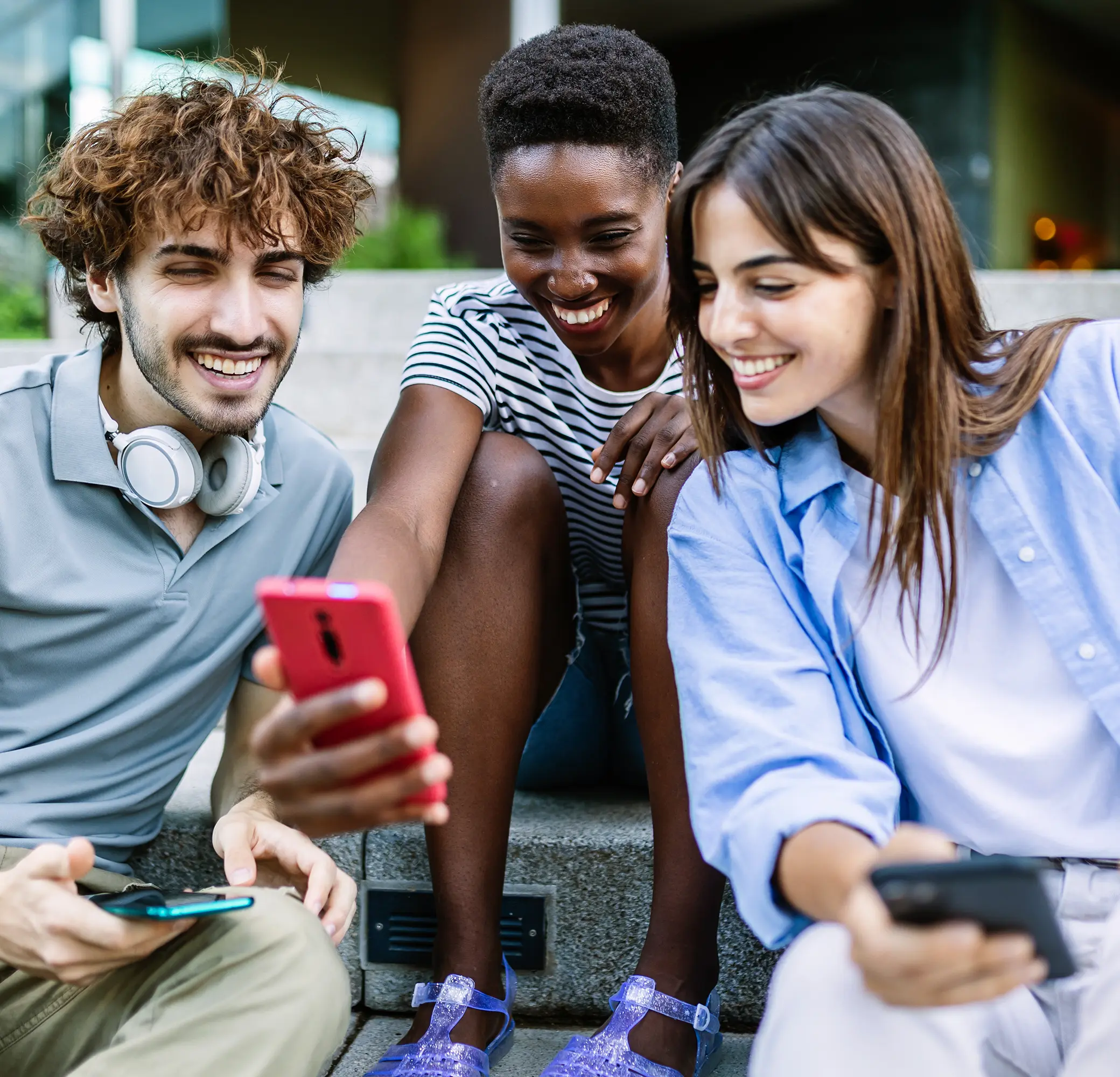 Three friends looking at a phone together