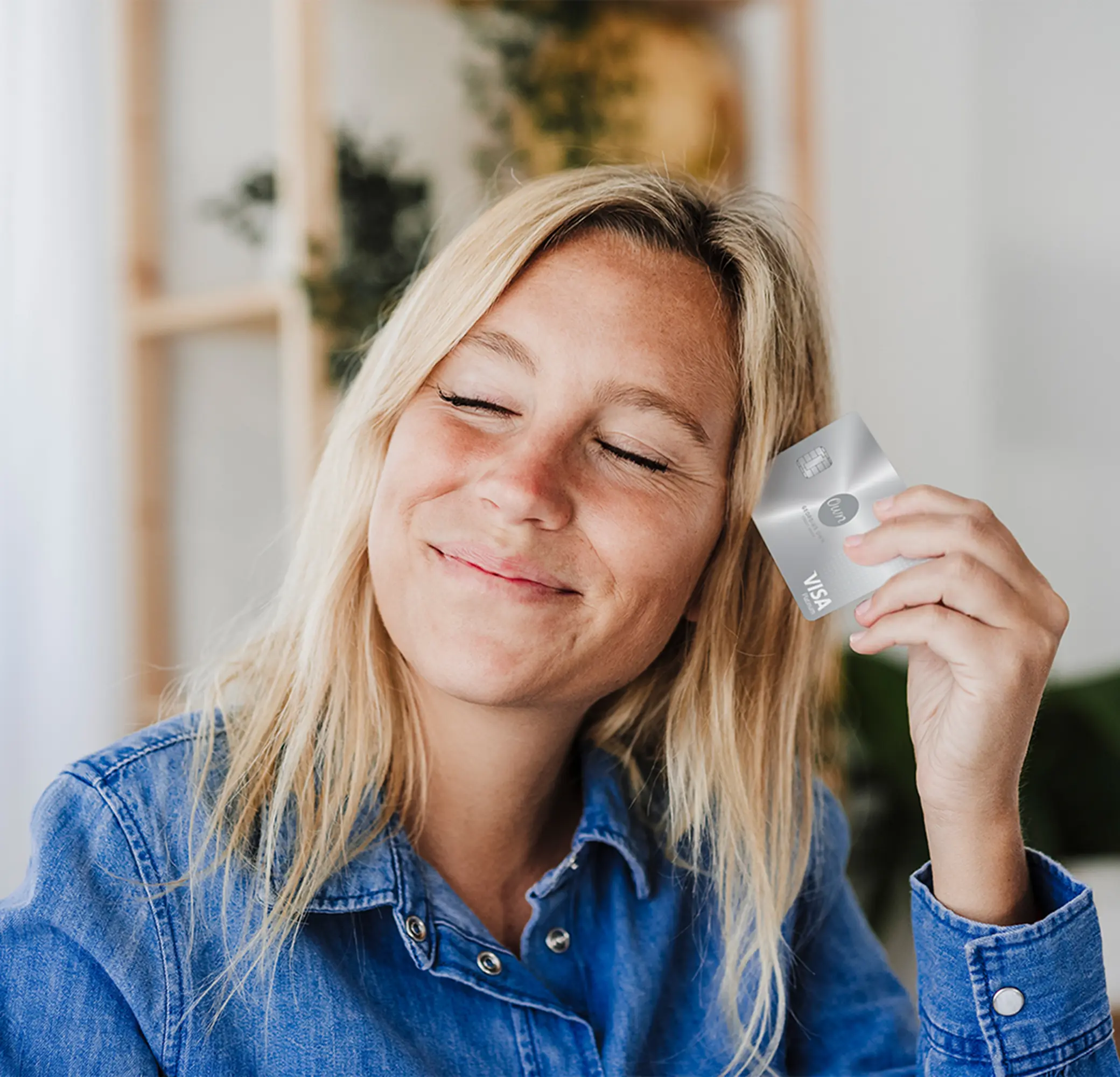 Woman holding her Visa Platinum card