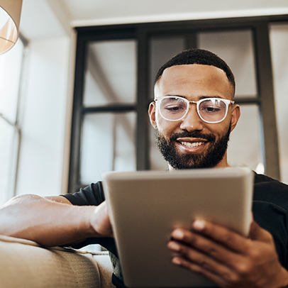 Black man, tablet and smile for social media post, shopping online or browsing internet creative content at home. Young africa american happy, relax and calm on tech digital app on device