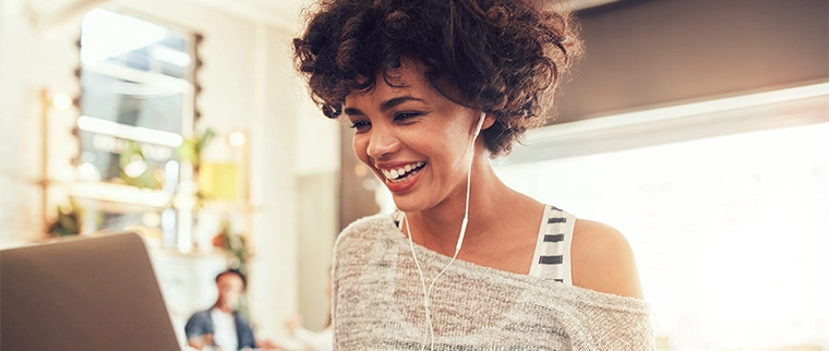 Woman smiling while on her laptop