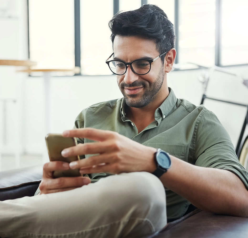 Man looking at his cellphone and smiling