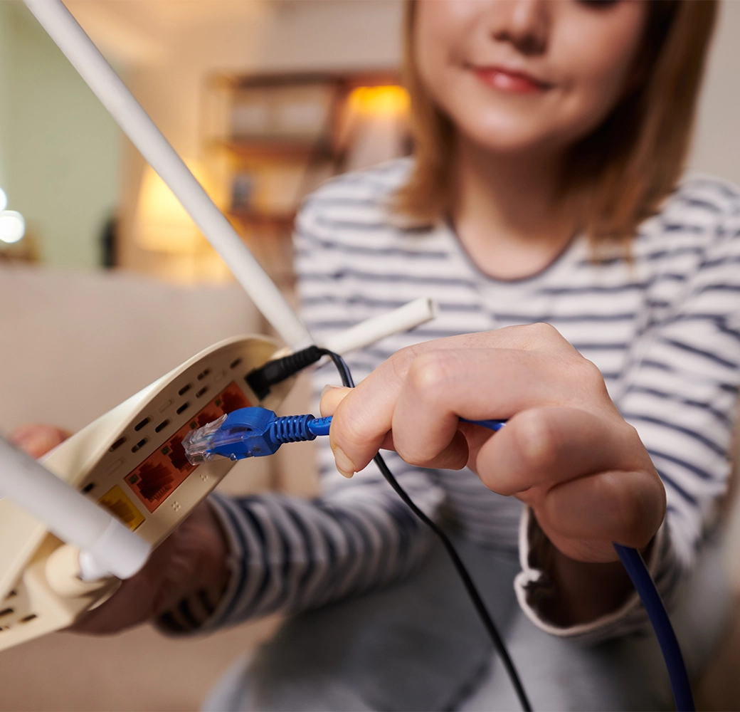 Woman plugging in wifi router