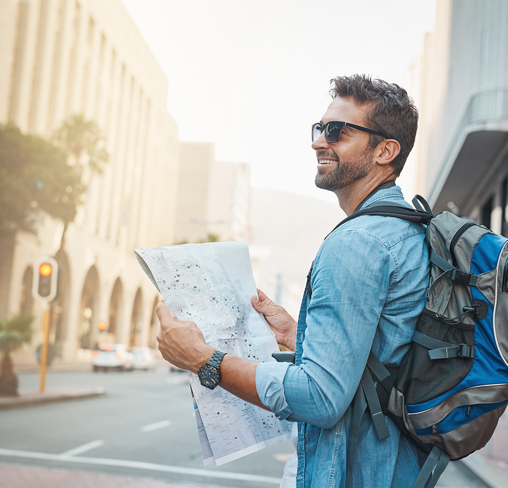 Man wearing sunglasses holding a map