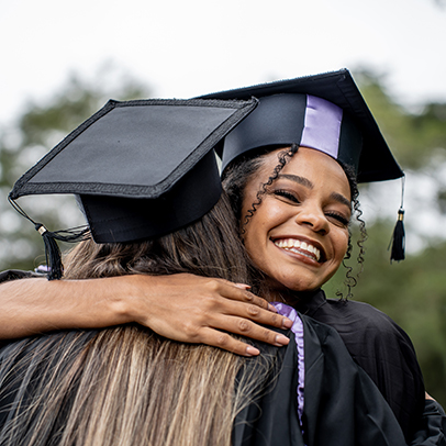 Hug of young people celebrating graduation day