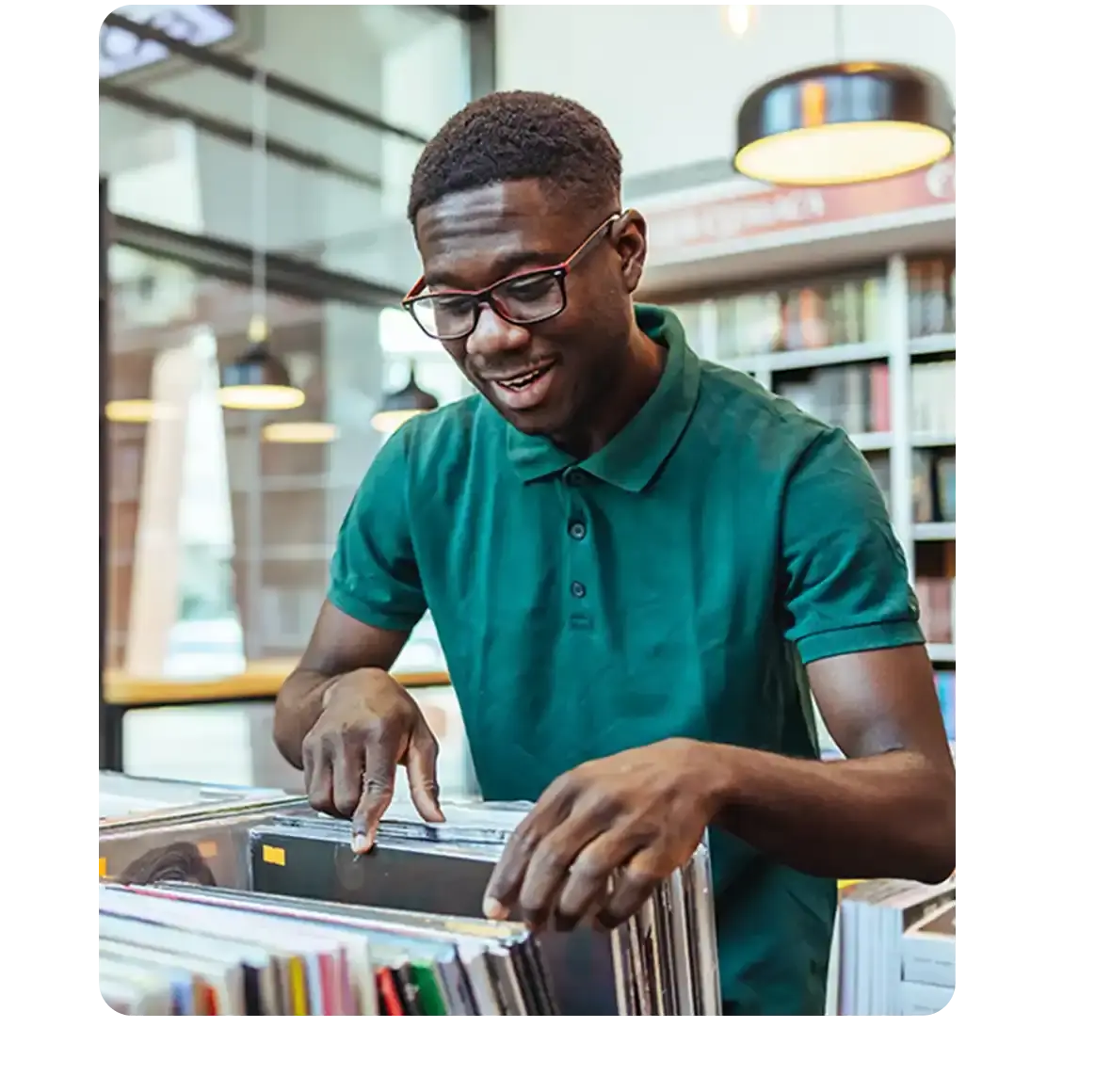 Man in record store looking through a stack of vinyl records