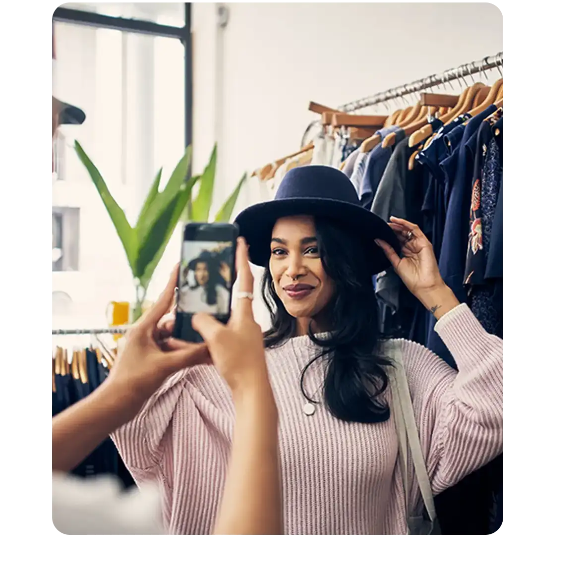 Woman shopping and trying on a hat