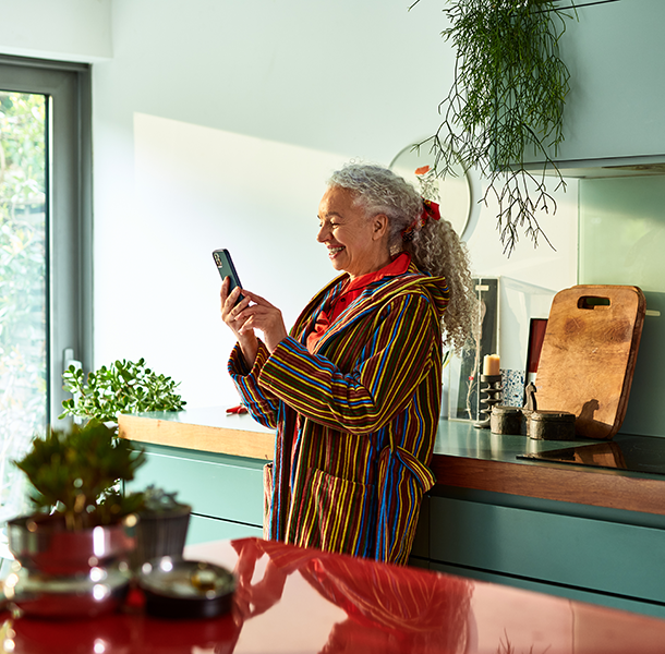 Woman in kitchen smiling