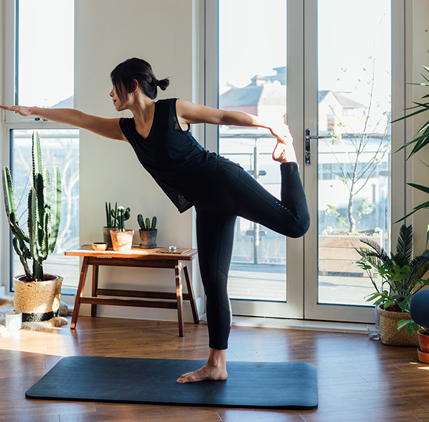 Woman doing yoga in house