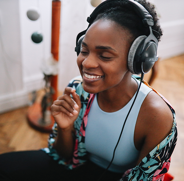 Woman listening to music at home with headphones