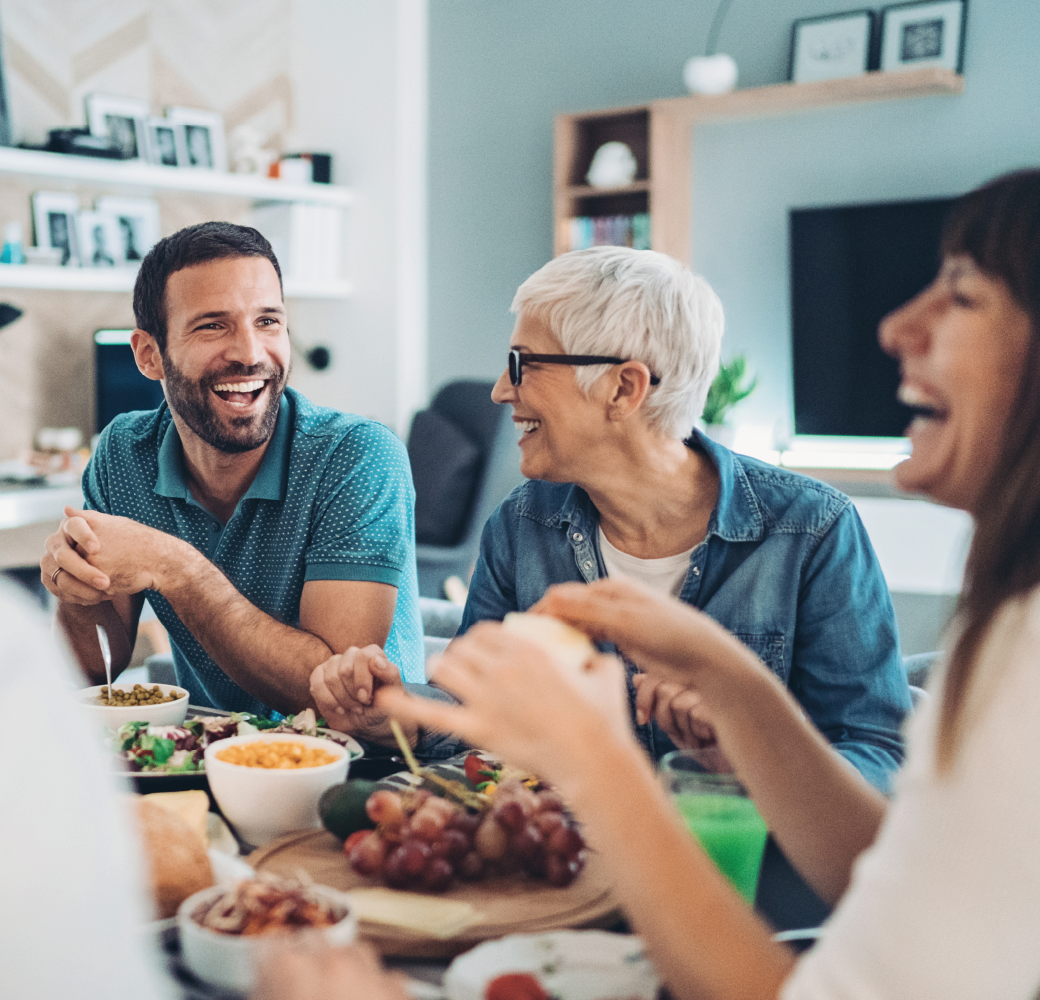 Extended family eating together, while laughing and talking, learning about parents finances.