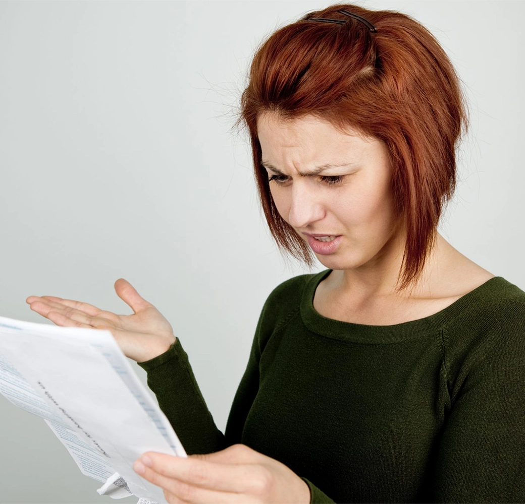 Frustrated woman looking at paper work