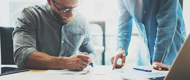 Man looking at papers with his financial advisor